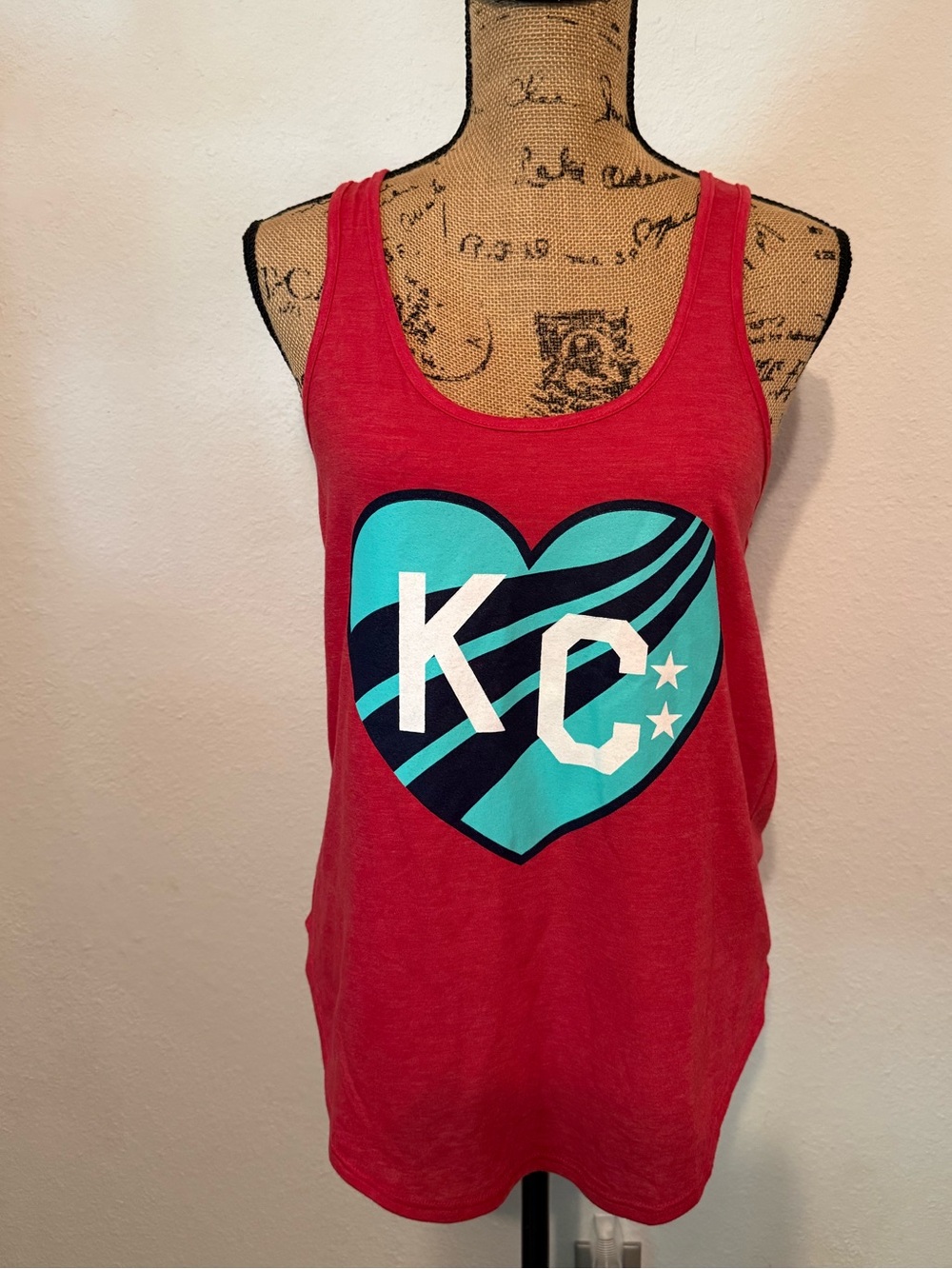 Charlie Hustle tank top features a turquoise KC Current heart graphic Medium